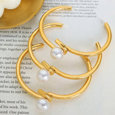 Close-up of twisted design with pearl inlay on gold cuff bracelet